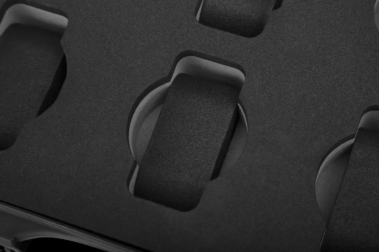 Close-up of a textured black surface with circular cutouts