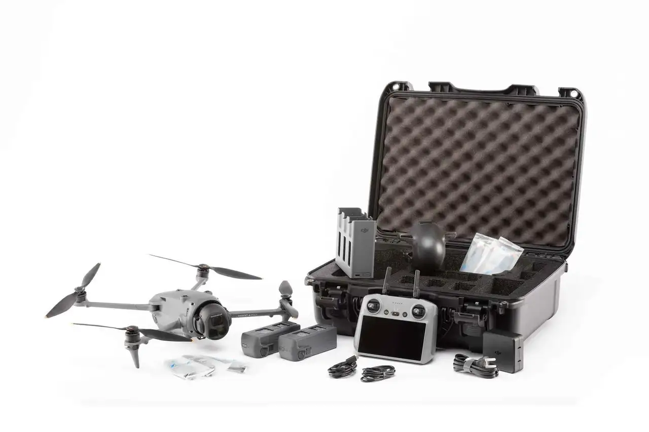 Drone with accessories and a black case on a white background