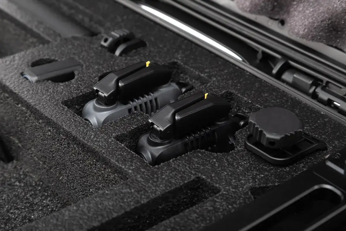Black foam-lined interior of a case with various components.