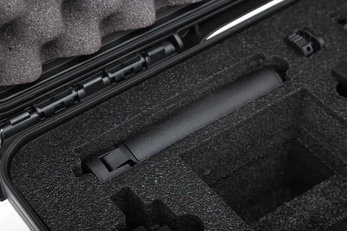 Black foam-lined protective case with a cylindrical object inside