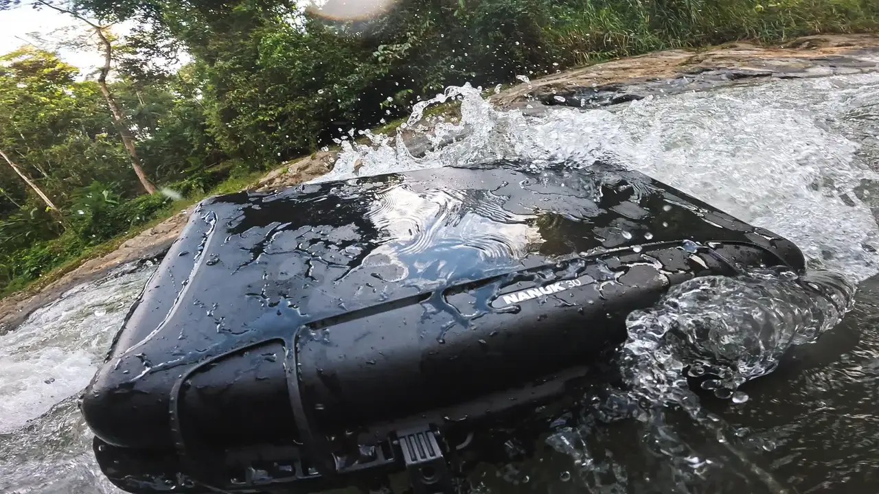 Car submerged in water with a forest background