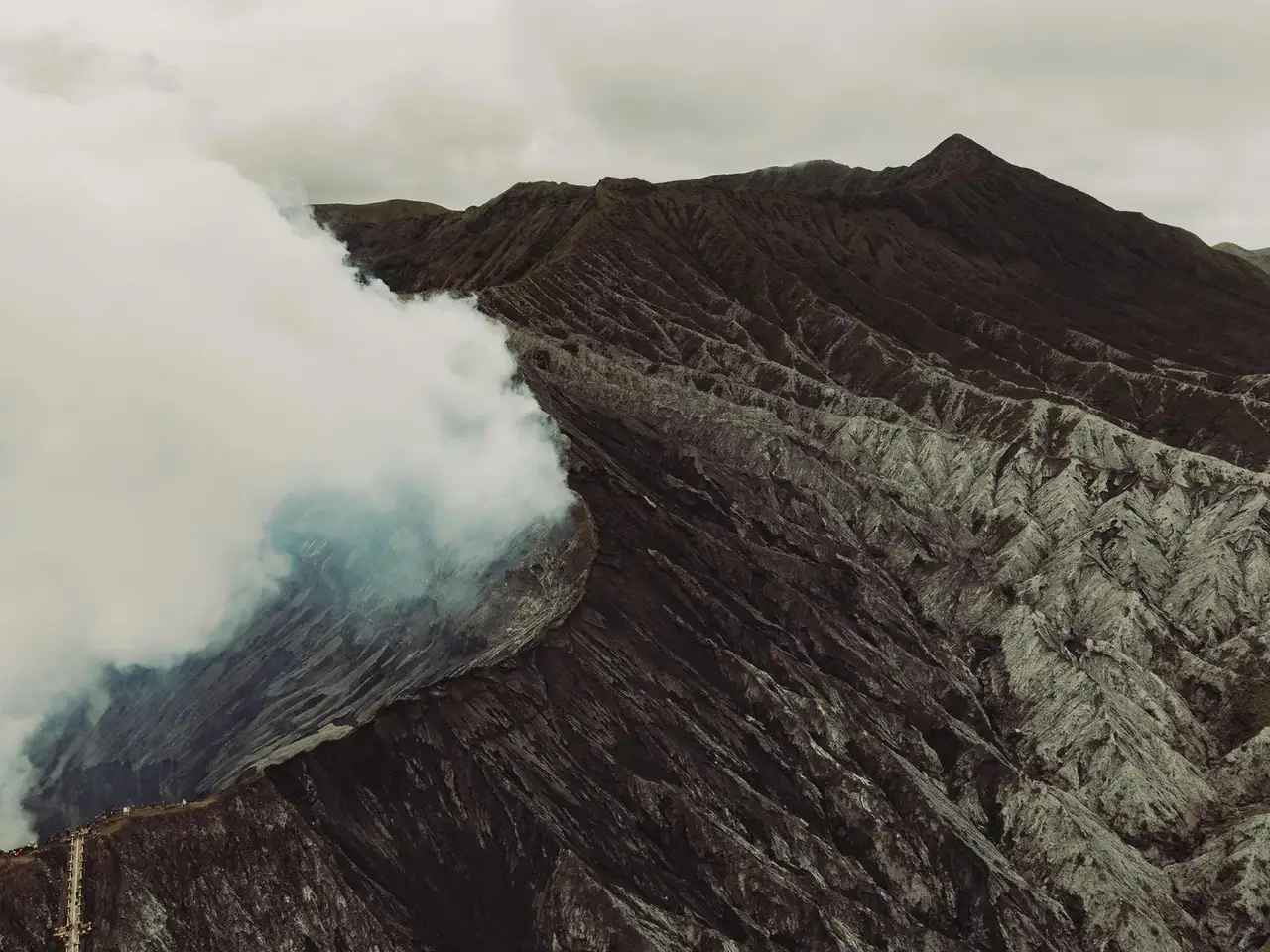 Volcanic landscape with smoke rising from a crater