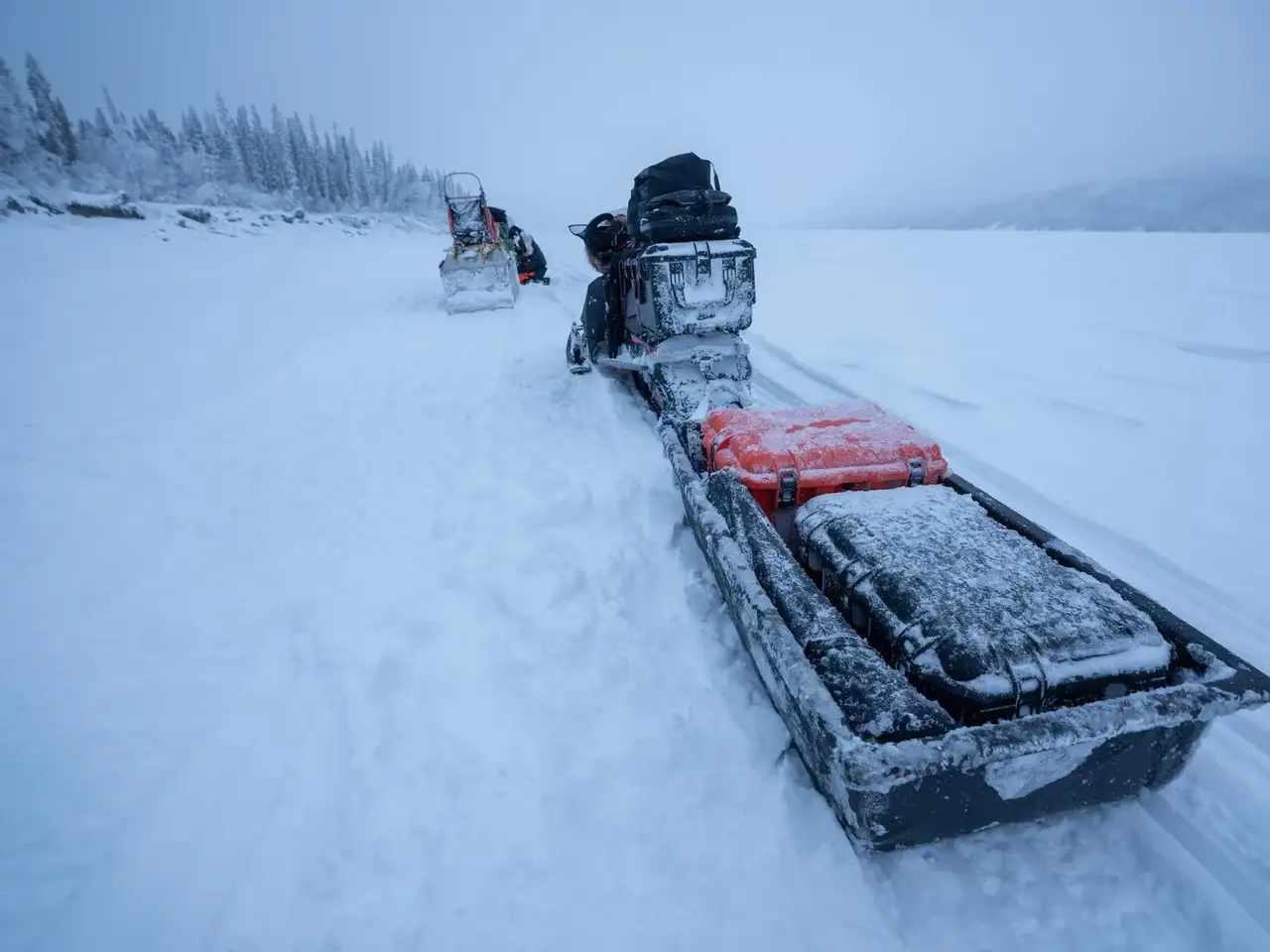 Snowmobile with equipment on a snowy landscape