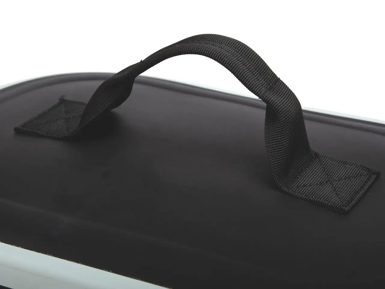 Close-up of a black hard case or bag with a padded top handle, photographed against a white background.