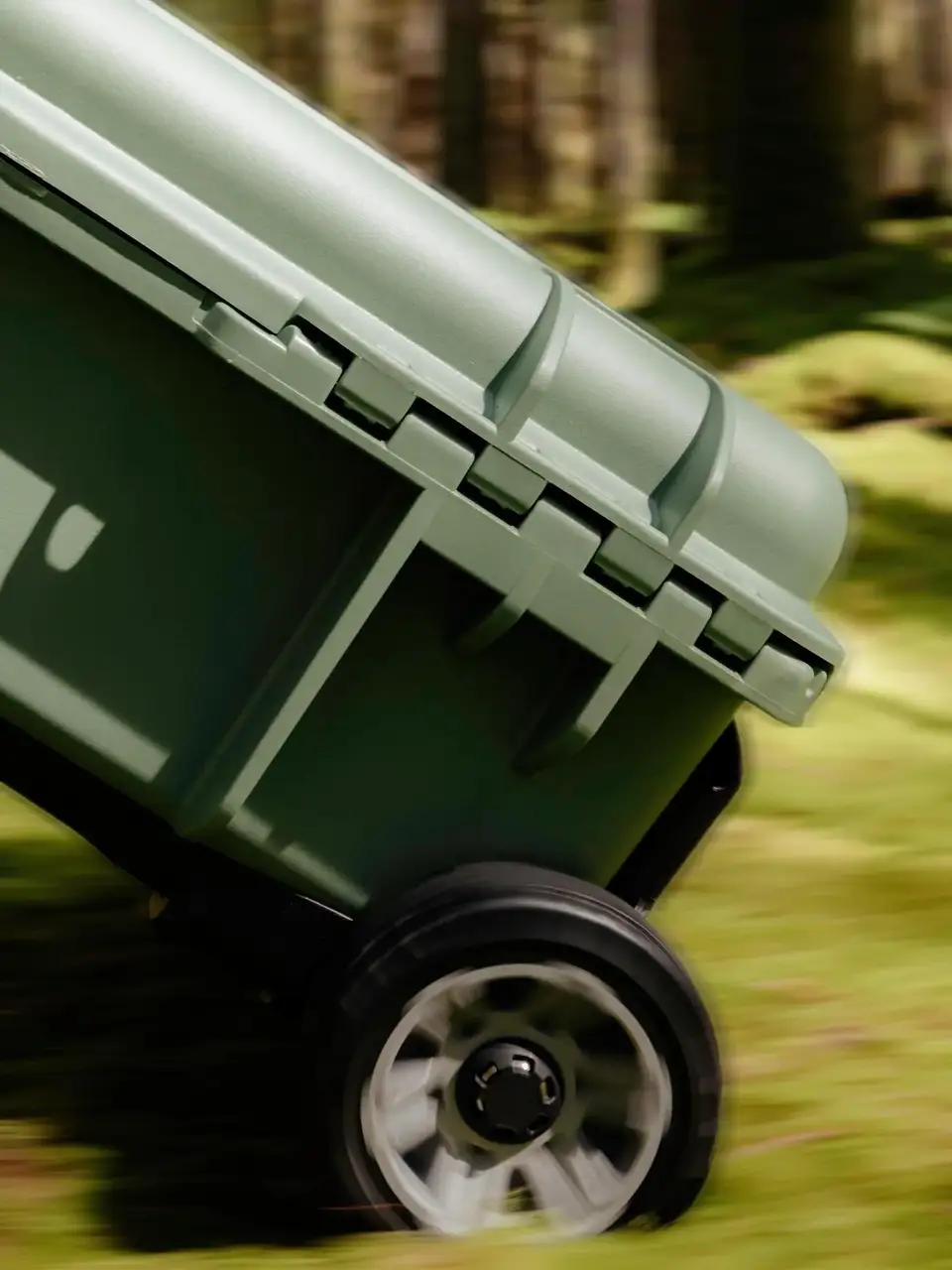 Green wheelbarrow on a grassy field