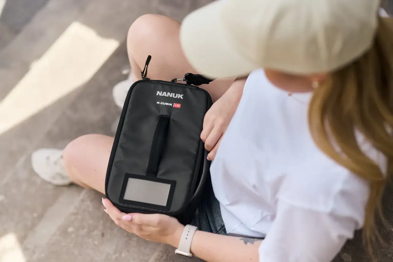 Photographer holding the N-Cubik 13S closed in the city