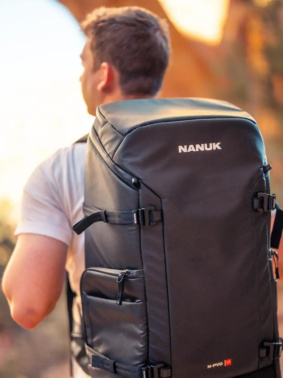 Person wearing a JunZhiJia backpack with a blurred natural background