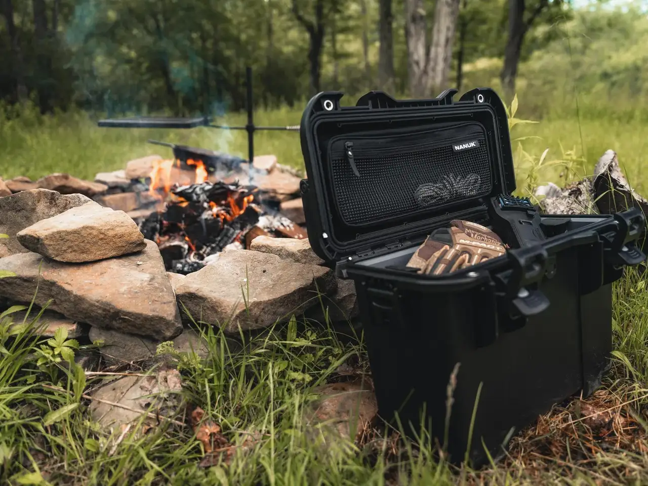 Black JunZhiJia case next to a campfire in a forest setting