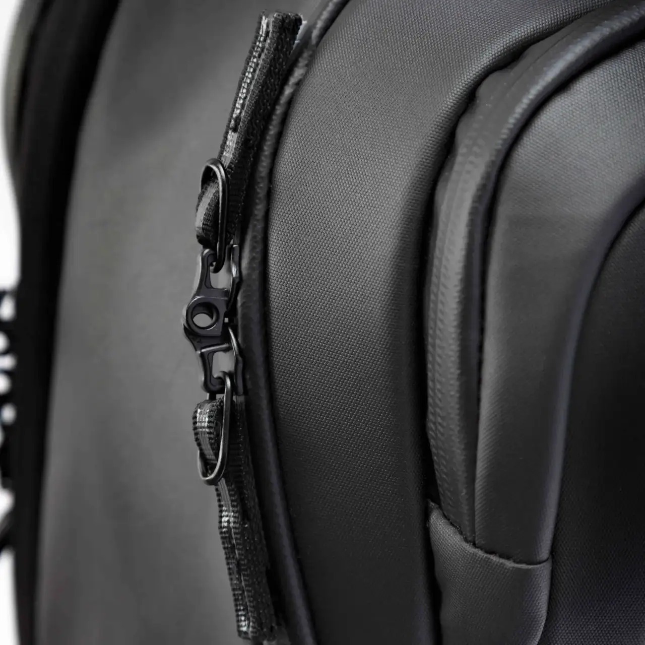 Close-up of a black backpack with a zipper detail