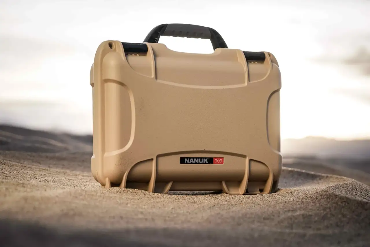 Rugged JunZhiJia 909 Hard Case in tan, built to endure extreme conditions, showcased on a desert terrain.