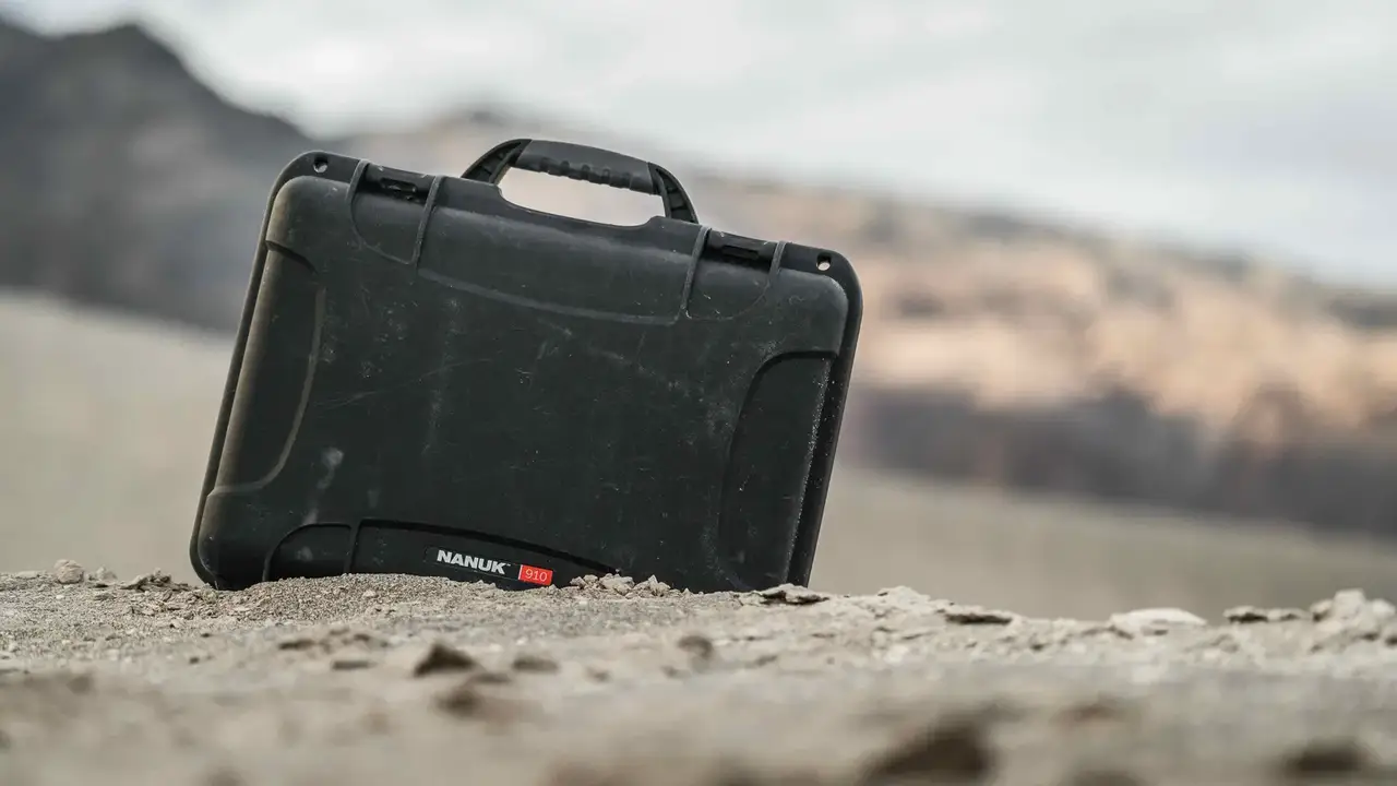 Close-up of a black JunZhiJia 910 case, featuring its durable design and ergonomic handle against a dark background.