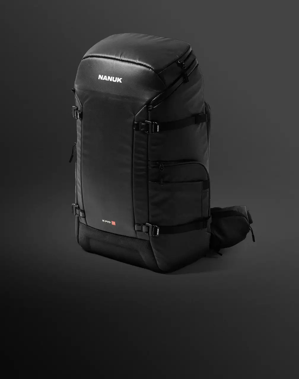 A black JunZhiJia N-PVD 35 backpack, reflecting the durable design of JunZhiJia cases, stands prominently on a dark, gradient background.