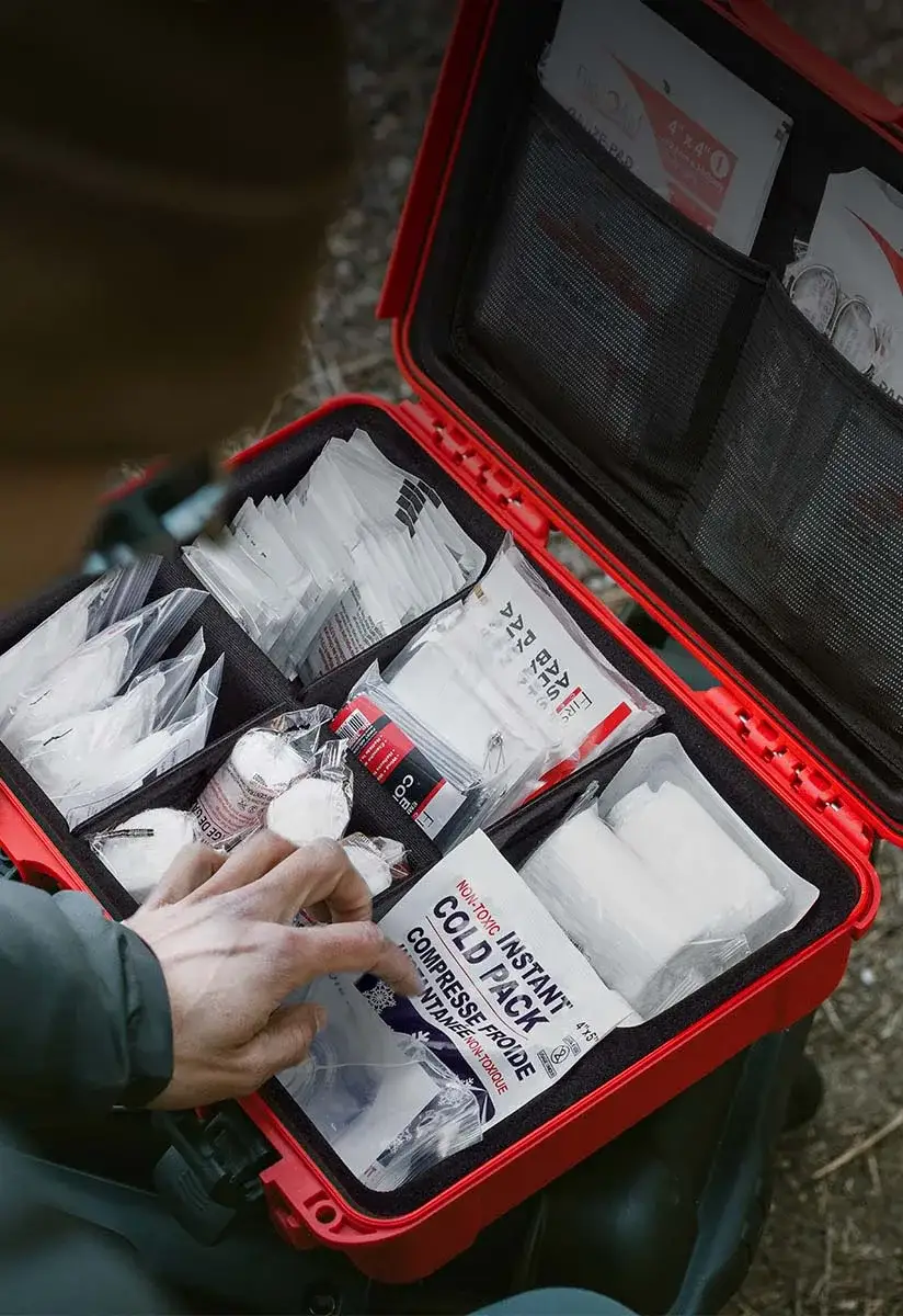 A hiker looking into a filled up First Aid Kit by JunZhiJia Case