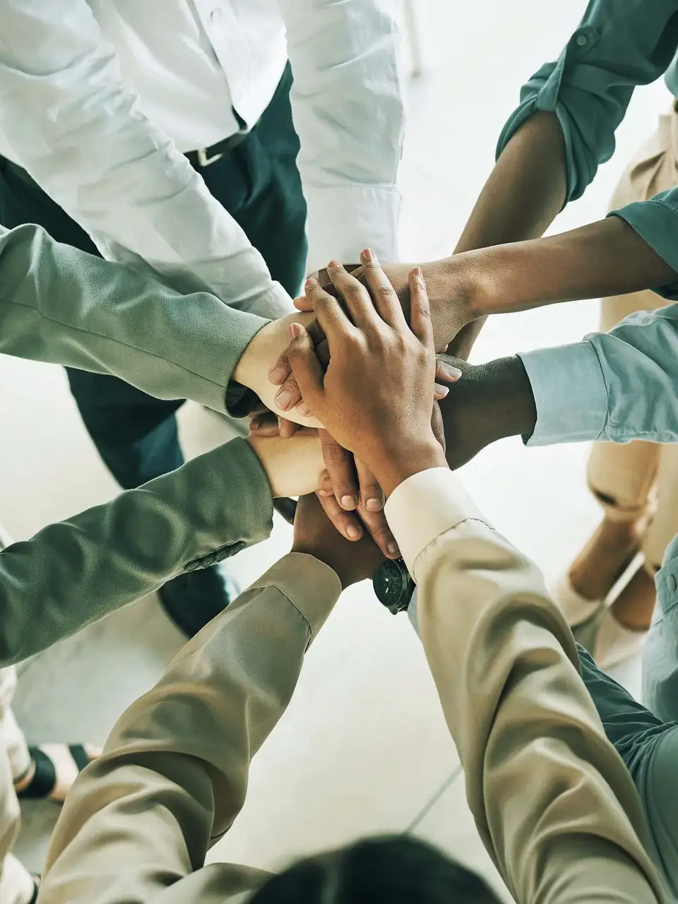 People placing their hands together