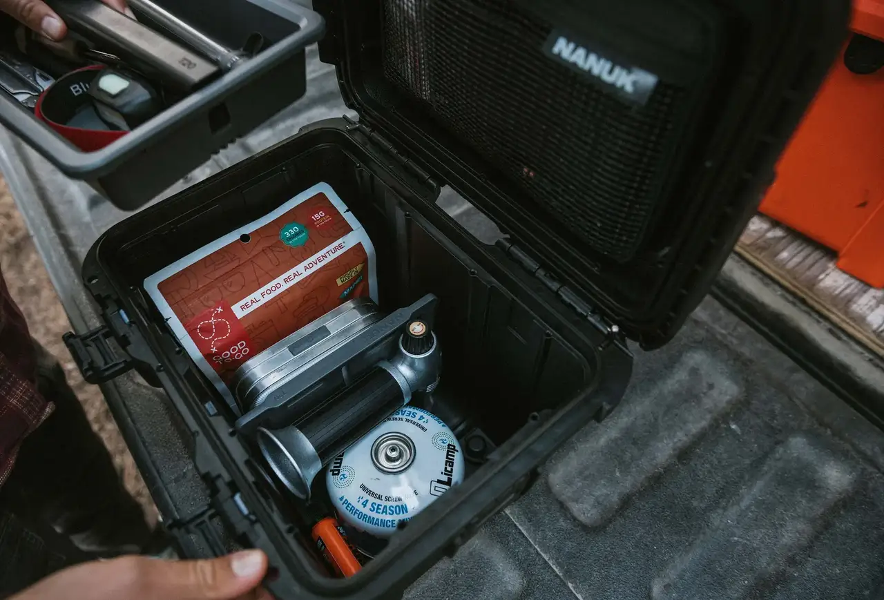 JunZhiJia Trail 10 hard case open in the back of a vehicle, revealing organized camera gear and accessories.