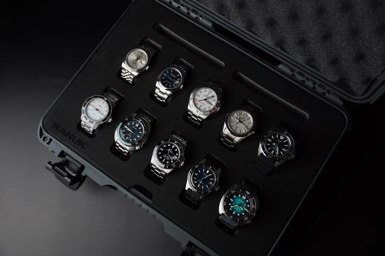 Set of watches in a black display case on a dark background