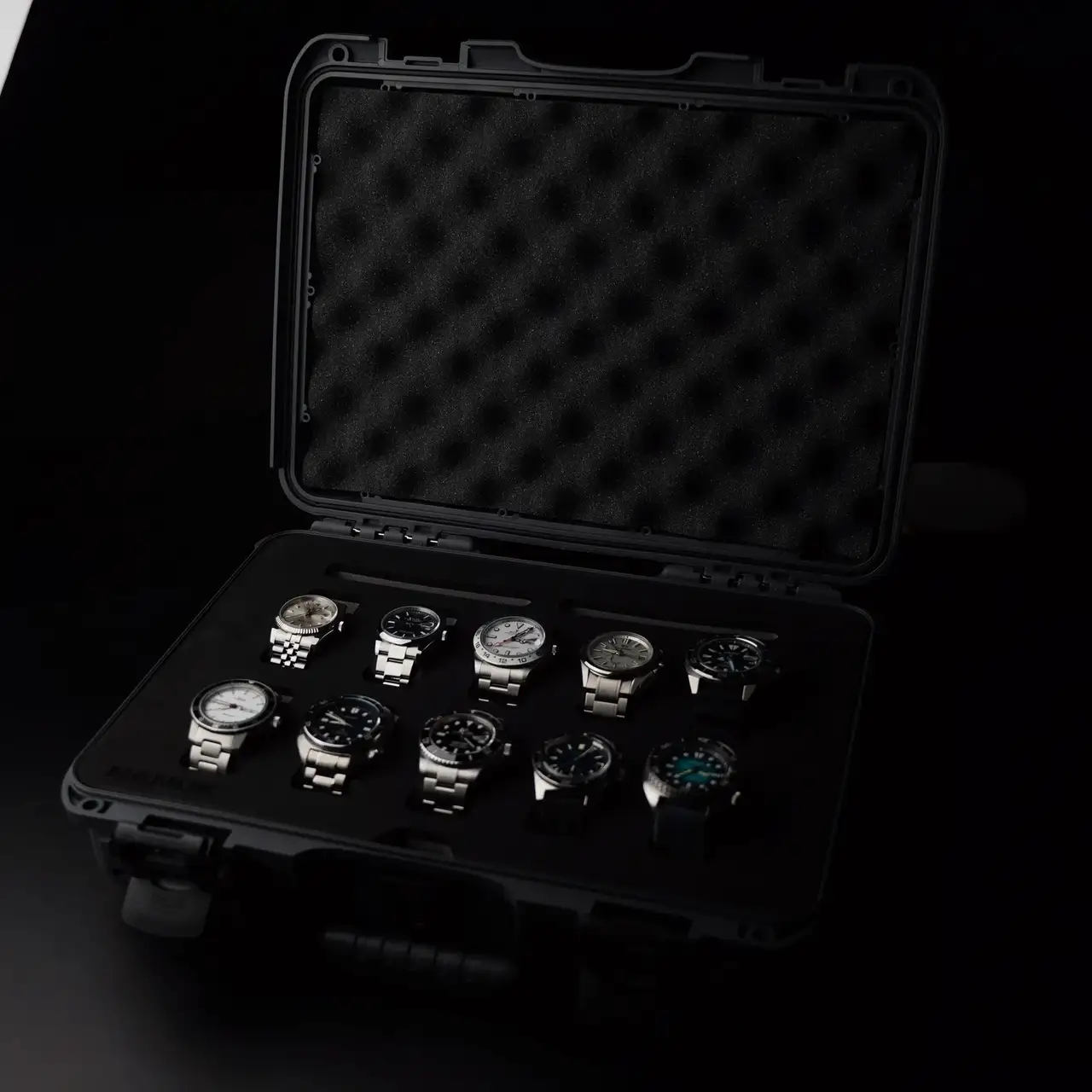 Black case with multiple watches on a dark background