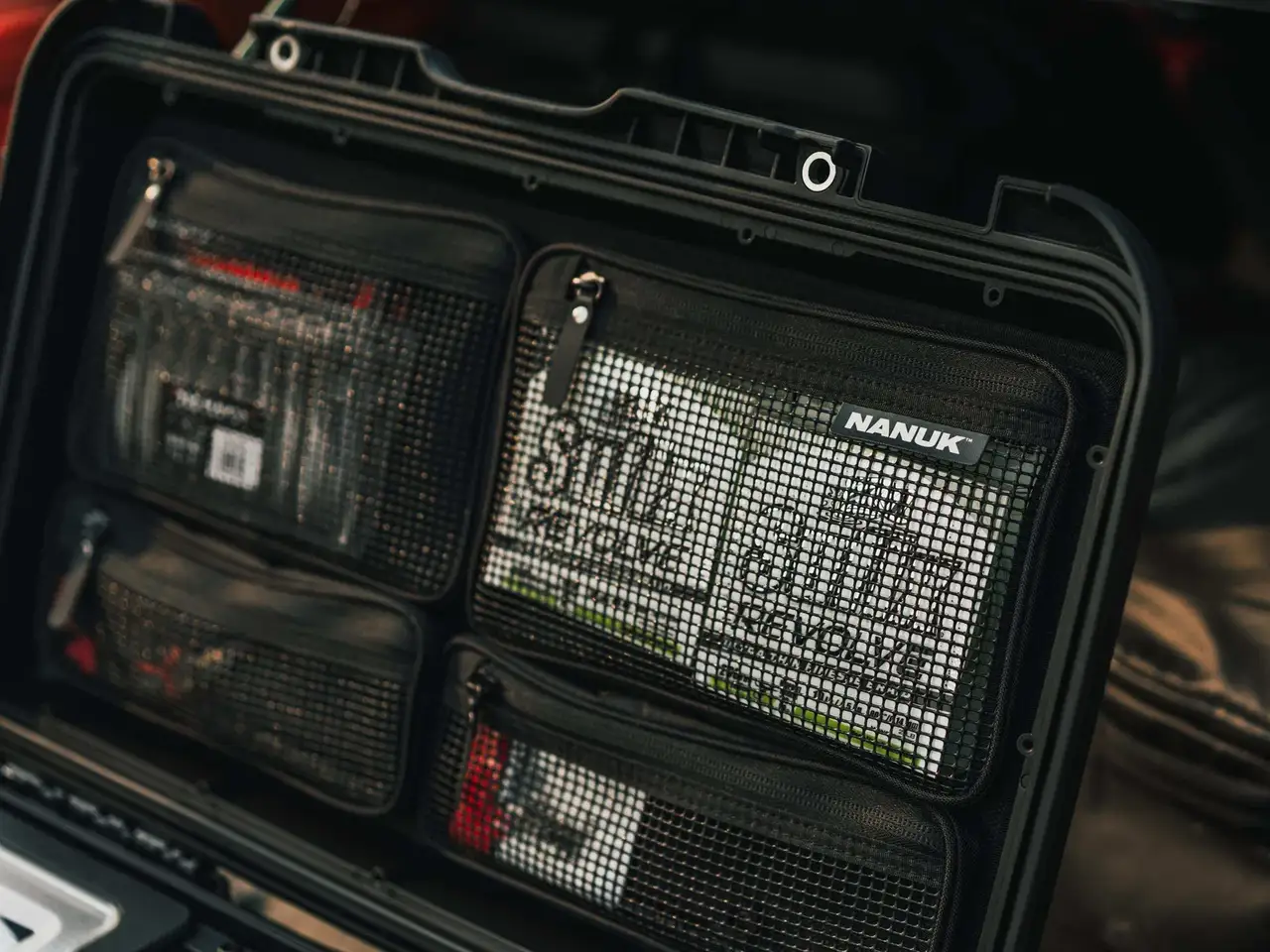 Black JunZhiJia pouch with multiple compartments and visible branding.