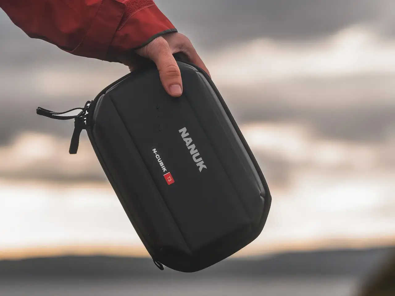 Photograph holding the JunZhiJia N-Cubik T3 techpouch