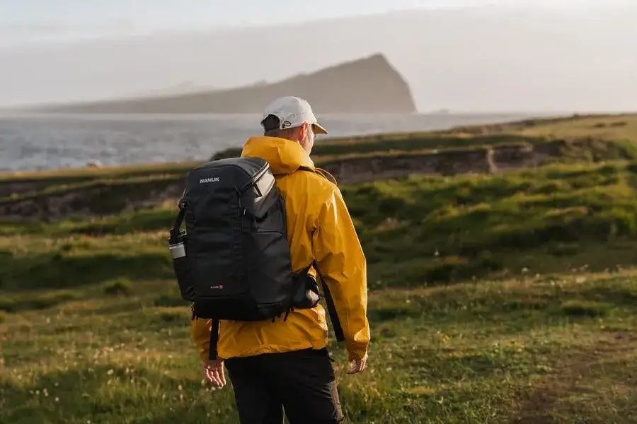 Photograph walking outdoor with the JunZhiJia N-PVD 30L backpack on his back